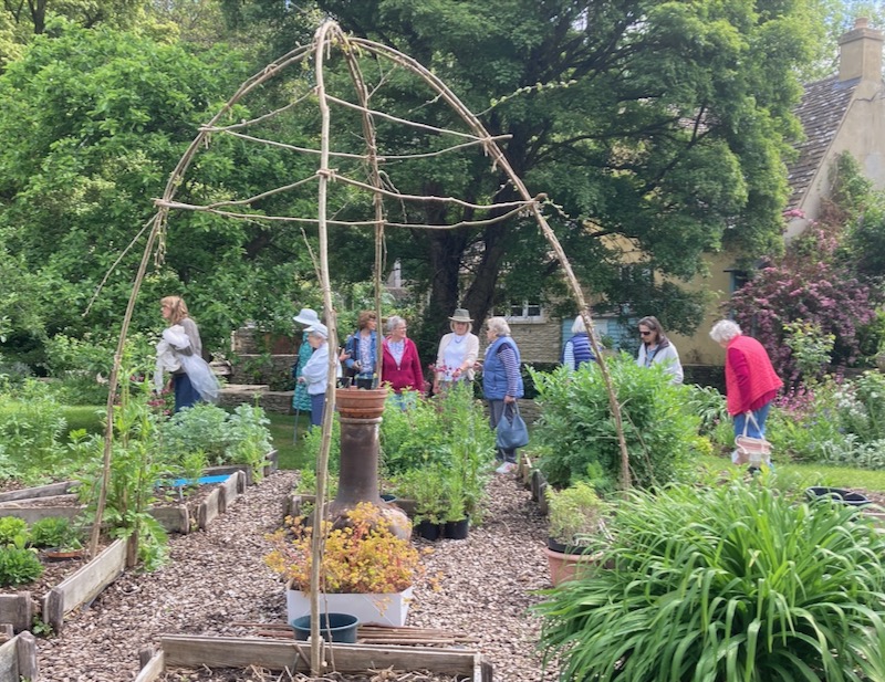 The u3a Floristry group in the herb garden at Shipton Mill